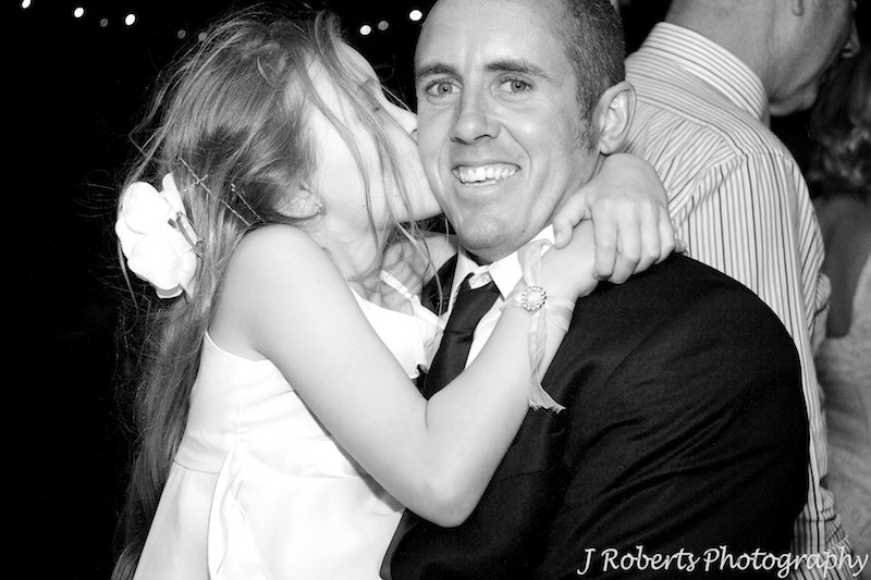 groom being kissed by his young daughter at end of wedding - wedding photography sydney